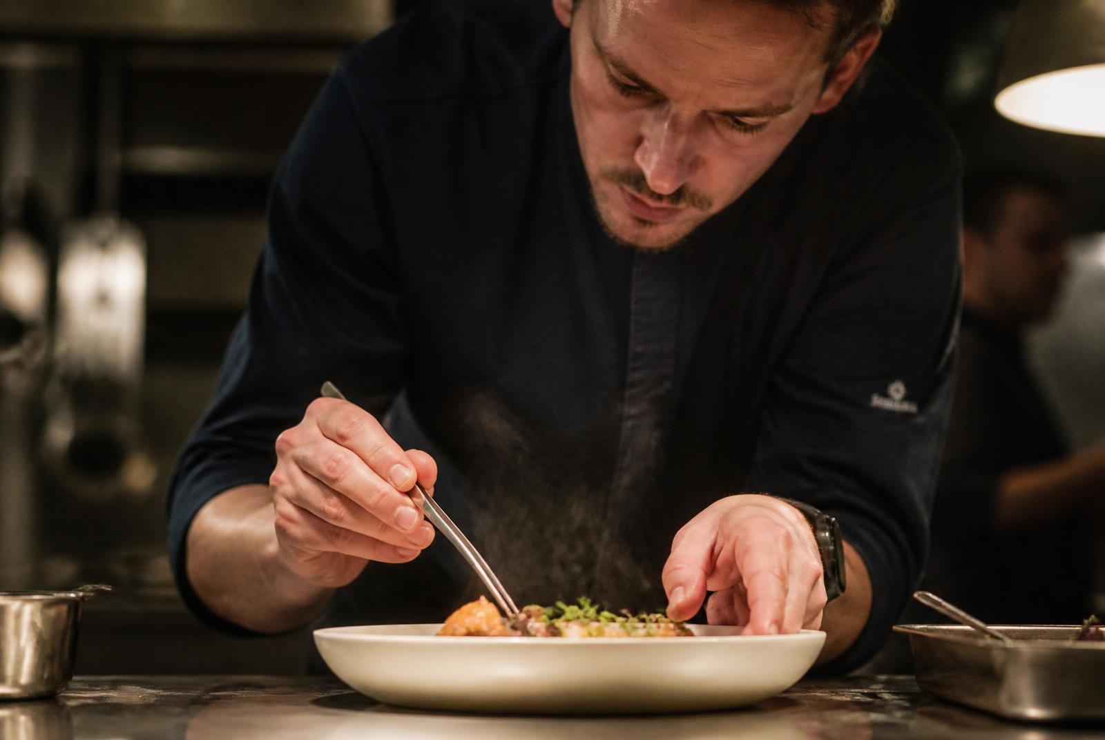 Private chef plating a tasting course